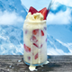 Strawberry Buttermilk Snowball in glass on wood table against mountainous backdrop